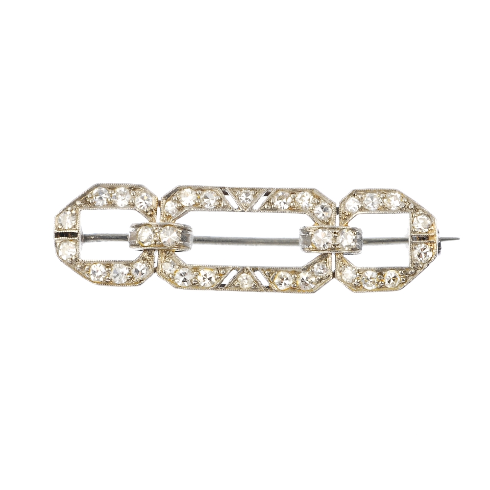 An early 20th century platinum and 15ct gold diamond brooch. Of geometric design, set throughout