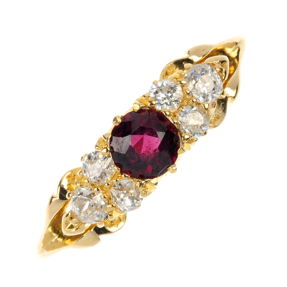An early 20th century 18ct gold garnet and diamond ring. The circular-shape garnet, with old-cut