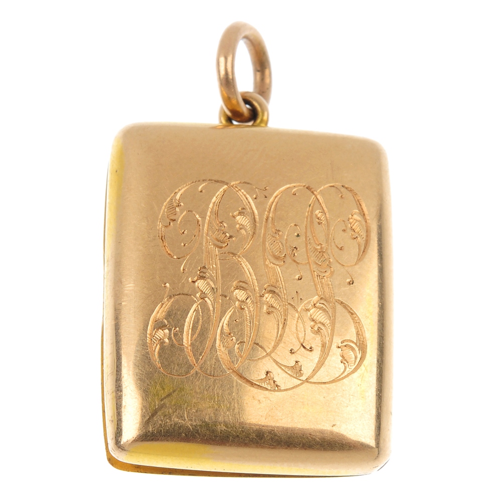 An Edwardian gold locket. Of curved, rectangular outline, with engraved monogram and date, to the