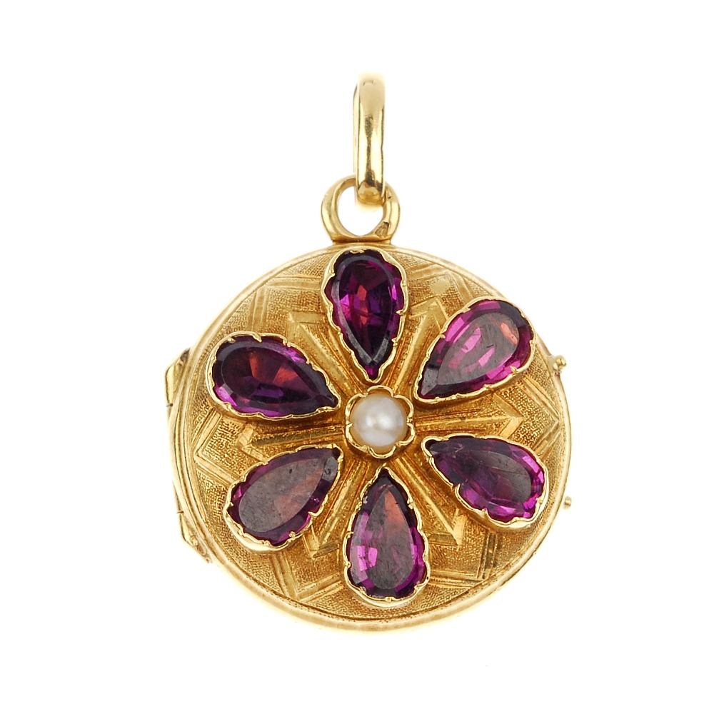 A late 19th century 15ct gold garnet and split pearl floral locket. Of circular-shape outline, the