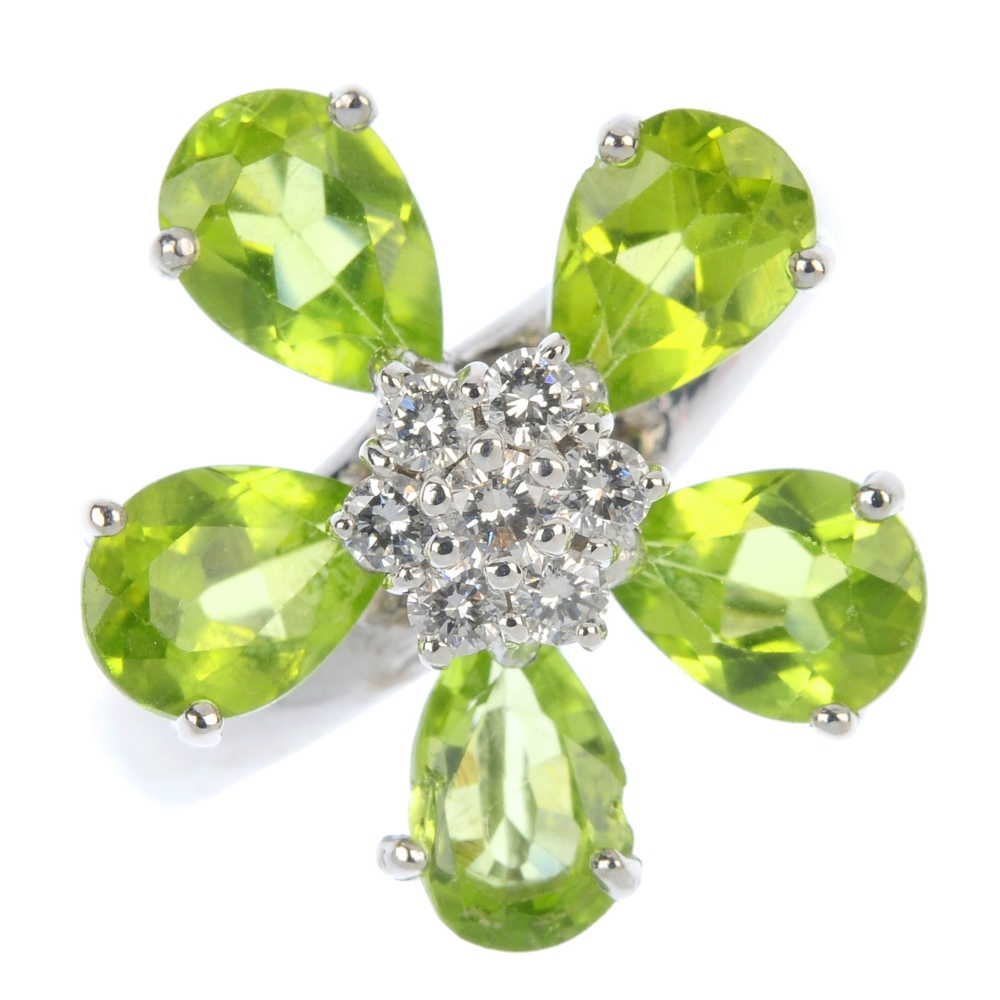 A peridot and diamond cluster ring. Of floral design, the brilliant-cut diamond cluster, within a