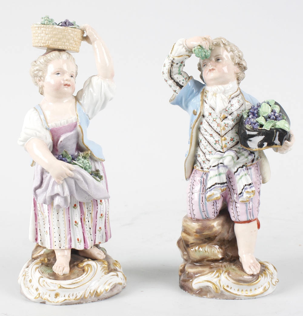 A pair of Meissen porcelain figures, modelled as male and female grape harvesters, he with grapes