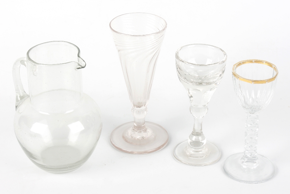 A collection of assorted drinking glasses, to include a writhen twist dwarf ale glass, penny lick