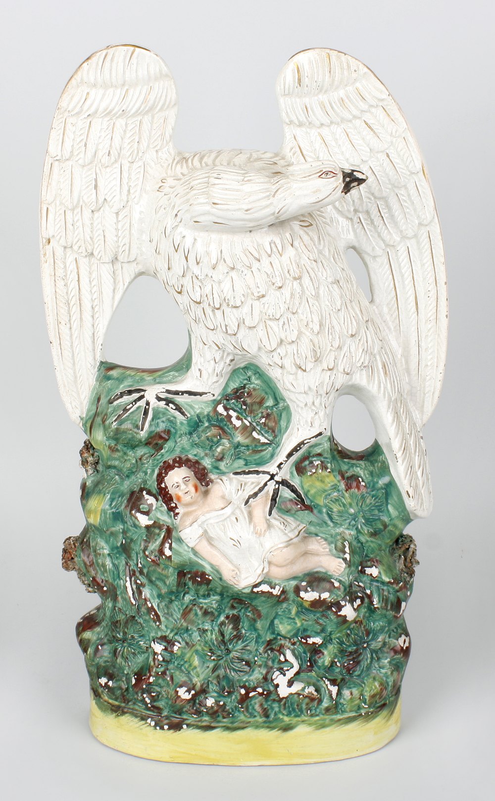 A rare mid Victorian Staffordshire pottery figure group of an eagle and child, the eagle with wings