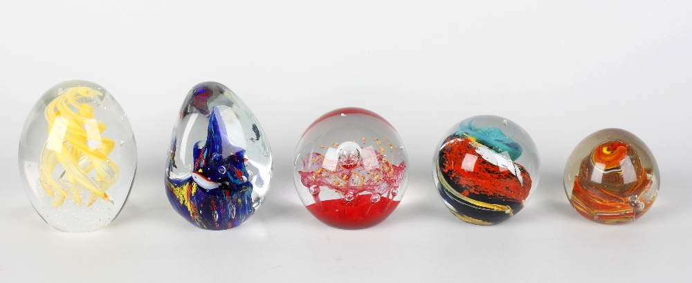 A group of assorted 20th century paperweights, most with multicoloured swirl decoration and of