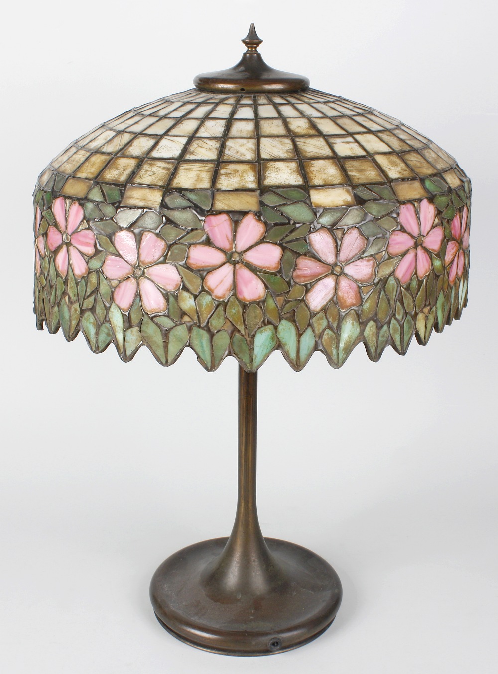 A good early 20th century Tiffany-style glass and brass table lamp, the domed top with spire finial