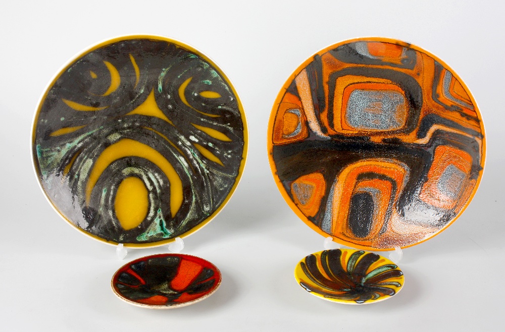Four Poole pottery `Delphis` dishes, two yellow 10.5"" and 5"" diameter, and two orange, same size.