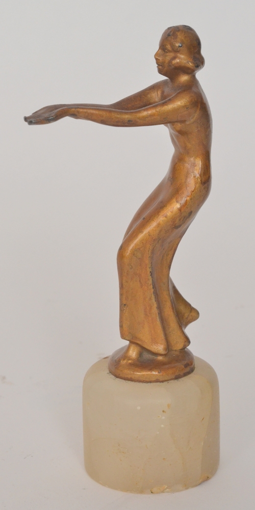 Unknown - A small 1930s Art Deco spelter figure of a dancing lady in evening dress raised to a