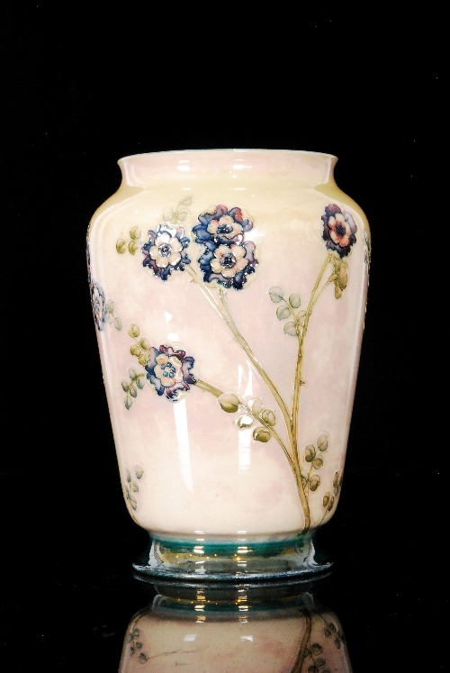 William Moorcroft for Liberty & Co - Prunus Lustre - A large footed barrel vase decorated with