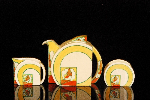 Clarice Cliff - Stroud - A Stamford shape teapot, milk and sugar circa 1932 hand painted in a