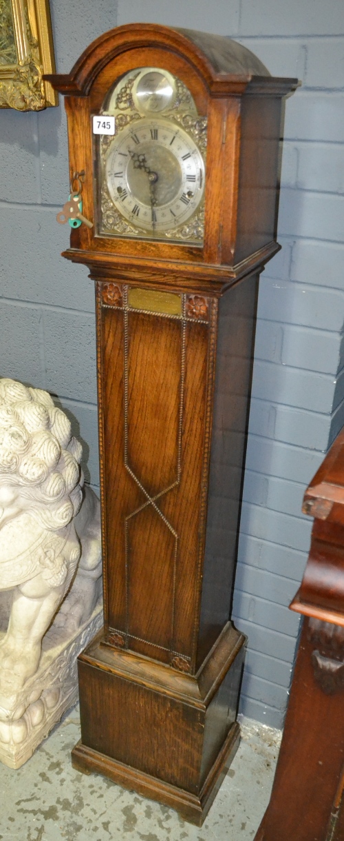A 20th Century oak cased Grandmother clock, the brass dial with a silvered chapter ring, Foreign