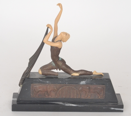 A 20th Century Art Deco style figure of a reclining dancer holding a drape on wedge base, length