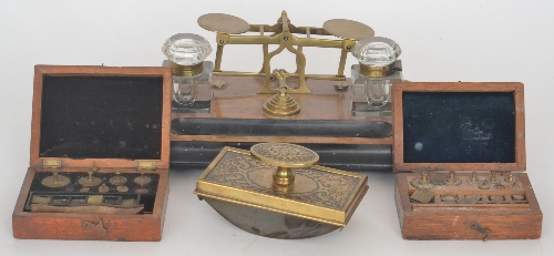 An early 20th Century rectangular ink stand and postal scale combination raised on four bun feet,