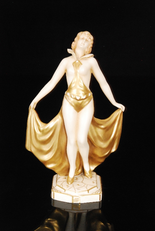 A 1930s Royal Dux Art Deco figure of a dancer with an exotic gold costume and matching gold shoes,