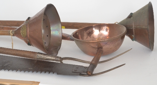 A 19th Century oak handled pitch fork, together with a twin handled saw, two copper wash dollies
