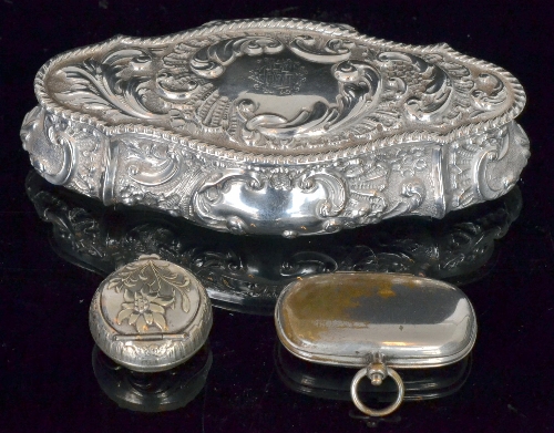 A Victorian hallmarked silver elongated oval box decorated with embossed foliate scrolls, length