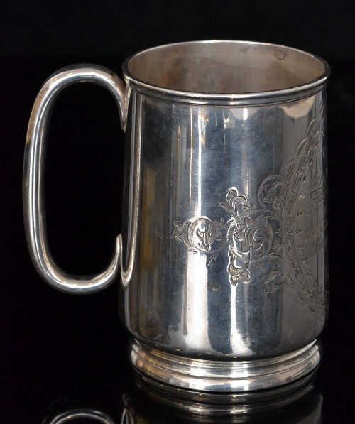A Victorian hallmarked silver tankard with presentation engraving, terminating in C scroll handle,