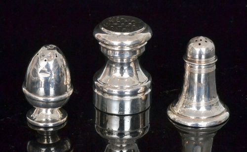 A small sterling silver pepperette together with two similar examples, S/D. (3)