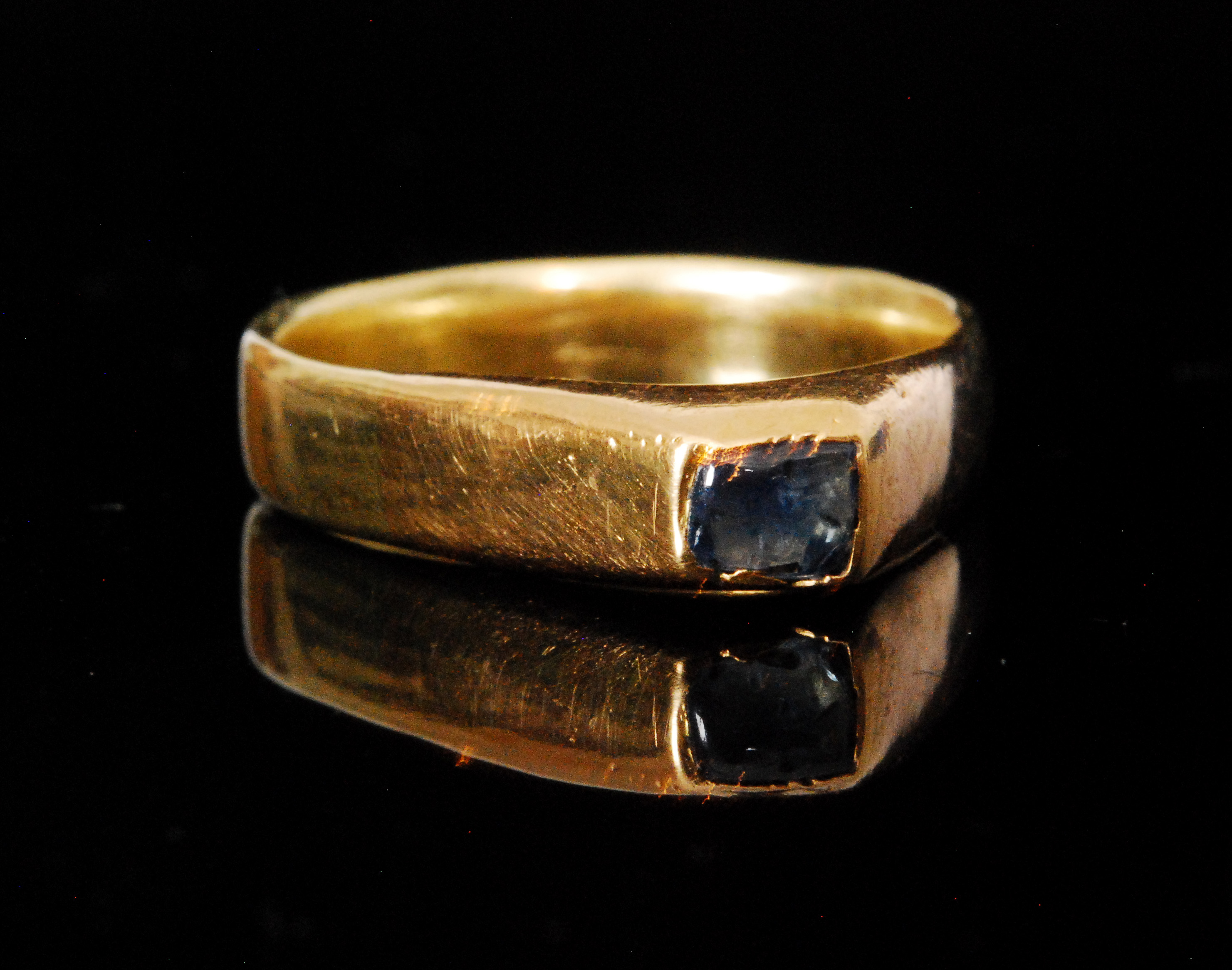 A Medieval gold stirrup ring set with a blue cabochon stone with later alterations to shank.