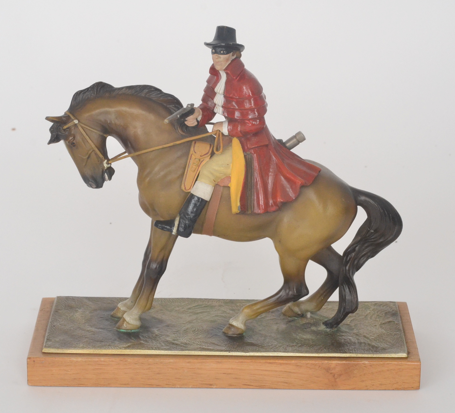 A 1950s Austrian painted spelter table lighter modelled as a highwayman on horseback with pistol