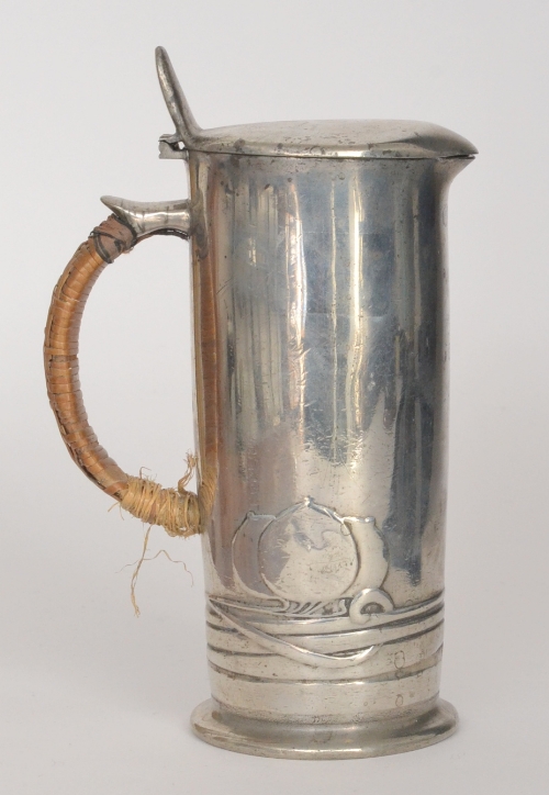 Archibald Knox - Liberty & Co - A polished pewter cylindrical hot water pot detailed with stylised