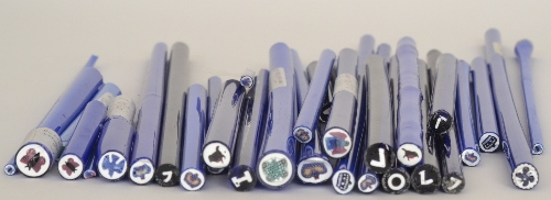 An assorted collection of original Whitefriars Glass paperweight canes to include letter and