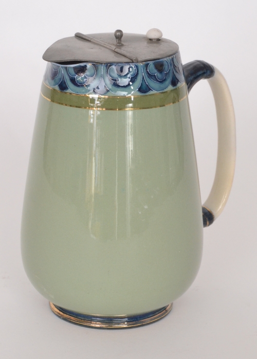 A late 19th Century Macintyre & Co Duraware water jug with pewter cover, the body in sea green with