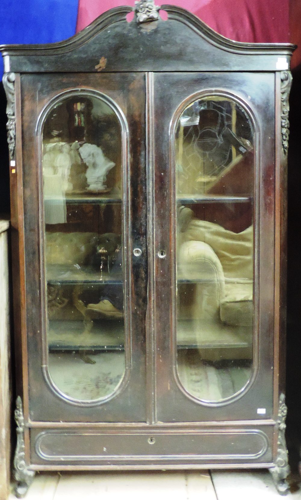 A small unusual 19th Century rosewood two door Bookcase, in the French style, the swan neck pediment