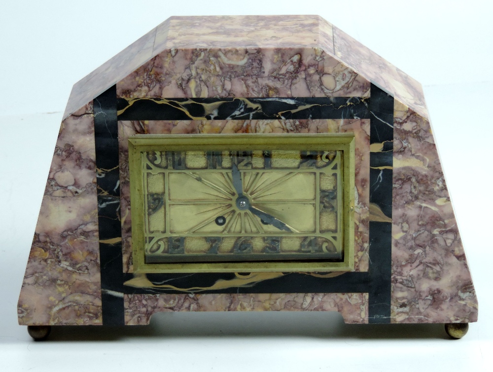 A large attractive Art Deco Mantle Clock, of pink speckled marble, the rectangular brass dial with