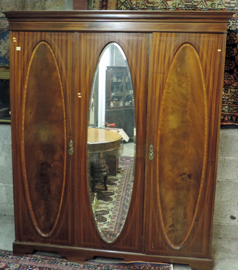 A good quality large inlaid mahogany Wardrobe, with centre oval mirror door flanked by two panel