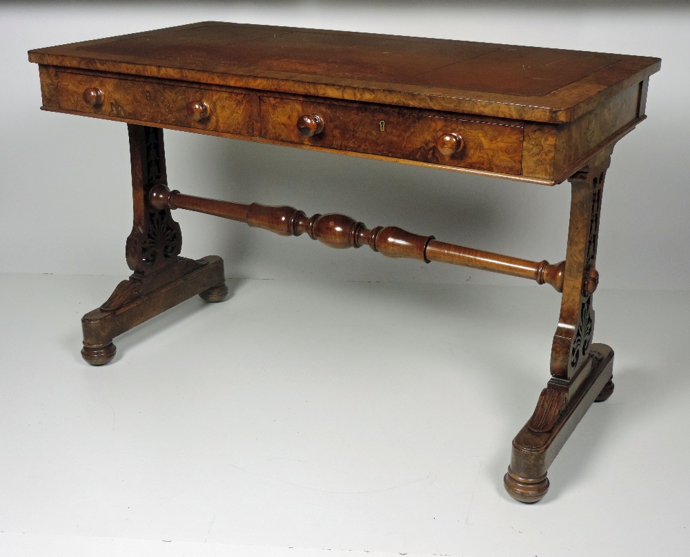 An extremely fine early 19th Century figured walnut Writing Table, the rectangular top with tooled