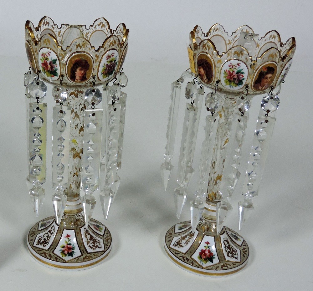 An attractive pair of Victorian Lustre Vases, with decorated floral portrait panels highlighted in