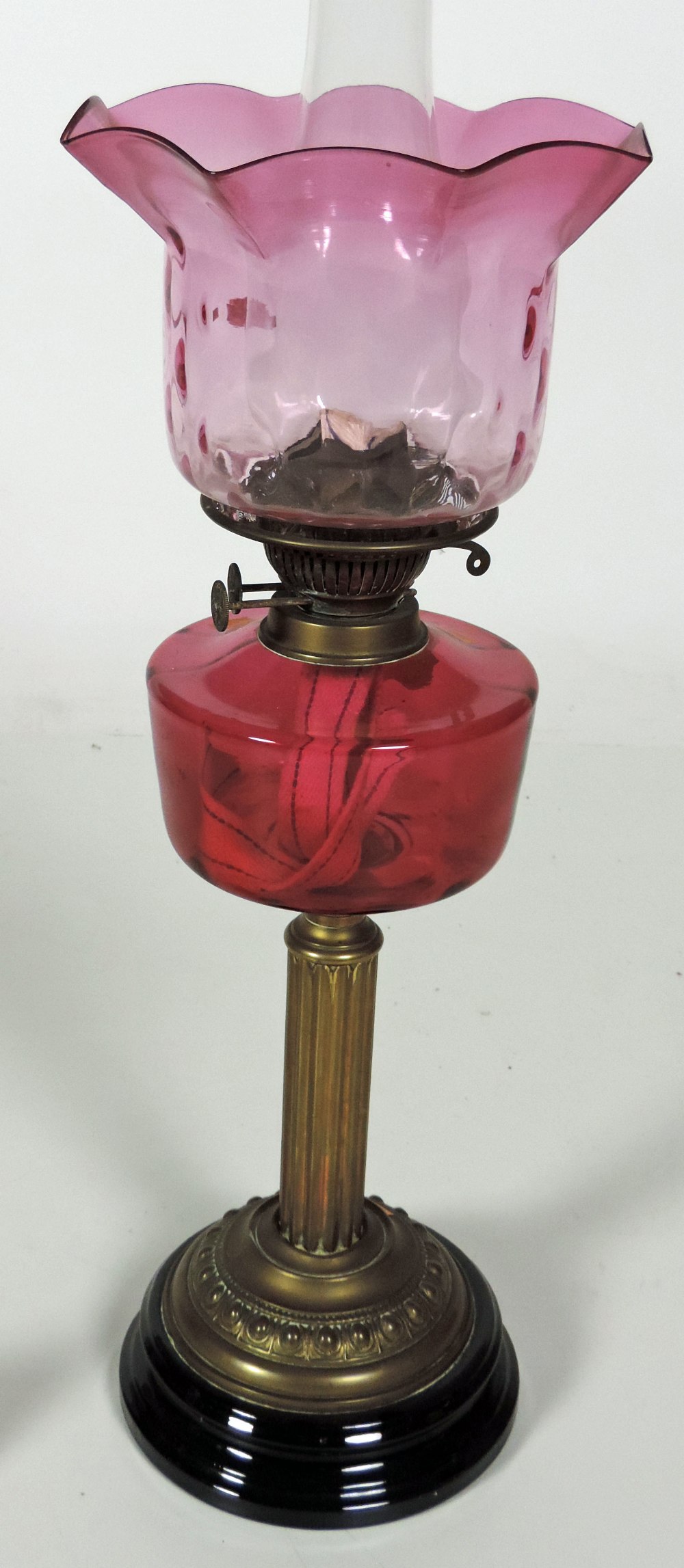 A late Victorian brass Oil Lamp, with ruby glass bowl and shade. (1)