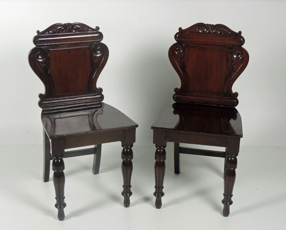 A good pair of William IV carved mahogany Hall Chairs, with turned front legs. (2)