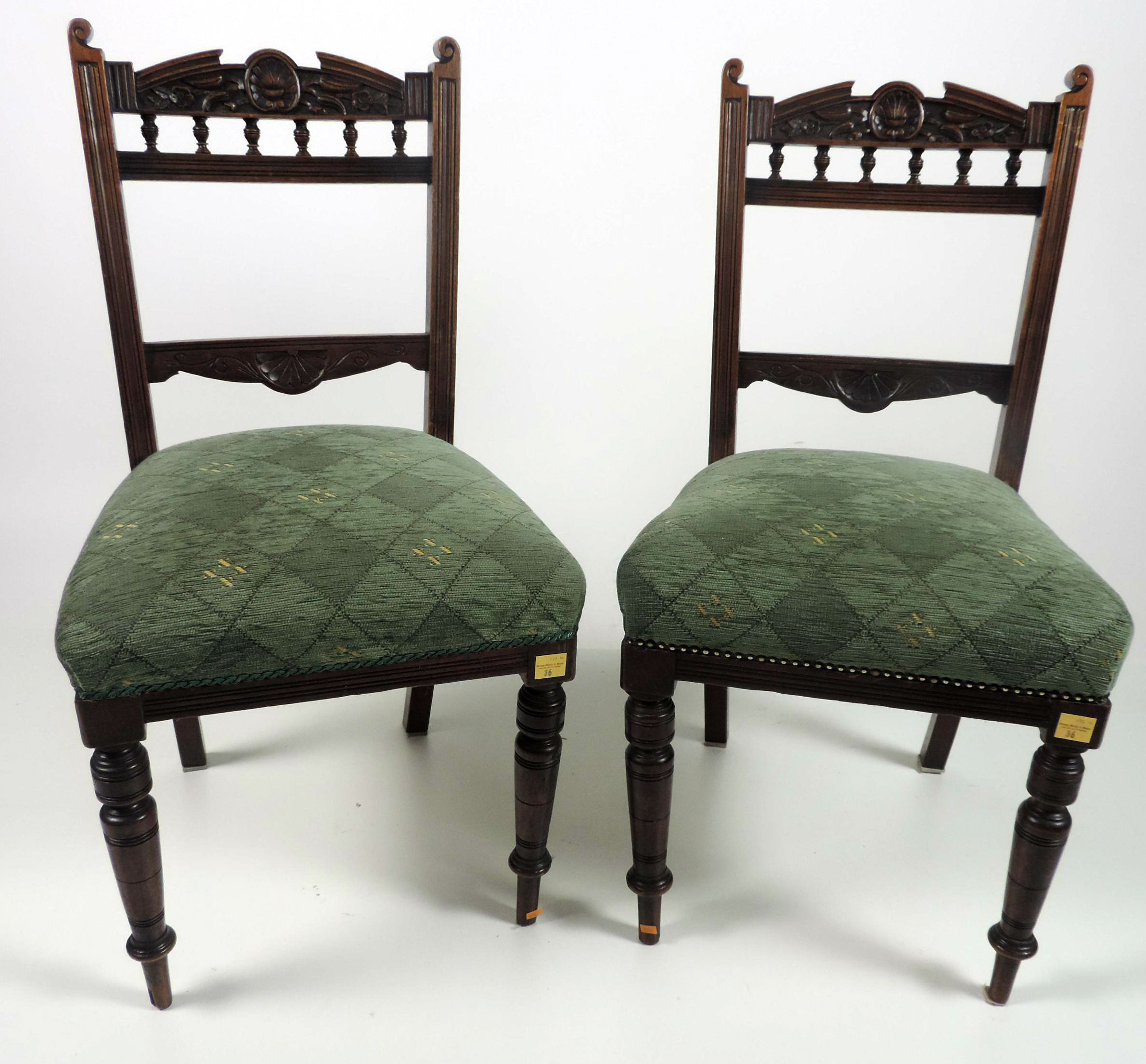 A set of 4 carved Edwardian walnut Dining Chairs, green upholstered seats. (4)