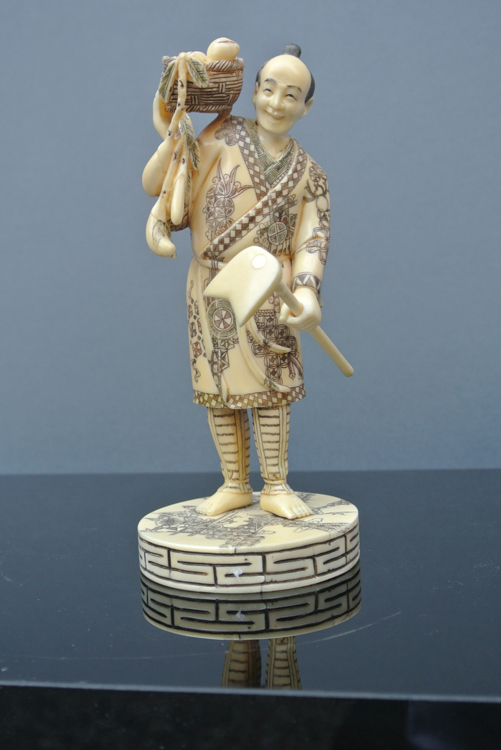 Japan School 19th century. An interesting carved and polychrome ivory sculpture of a farmer with a