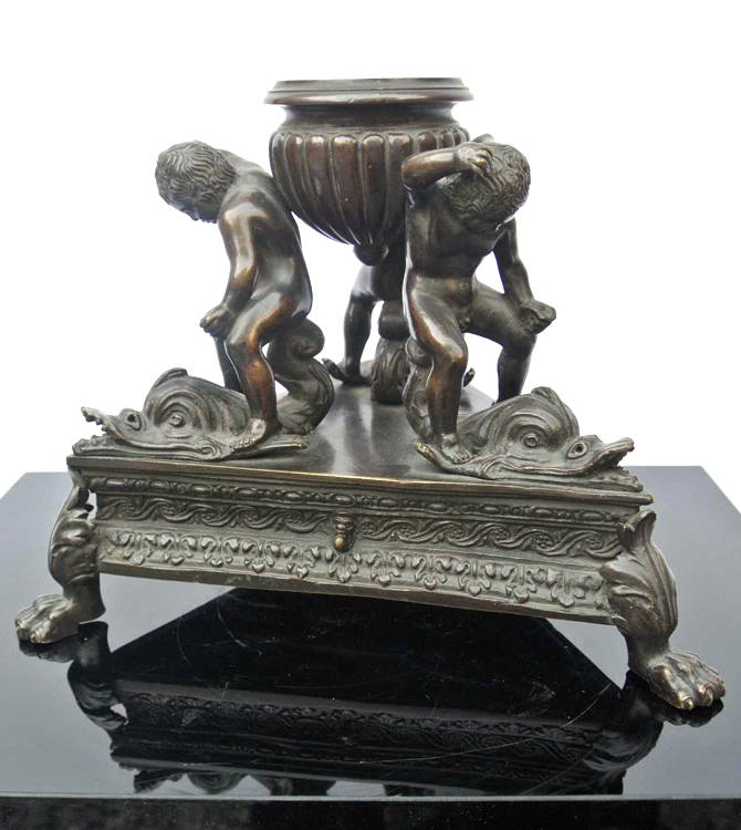 Venetian School late 18th century. A rare burnished bronze inkwell in the form of putti riding