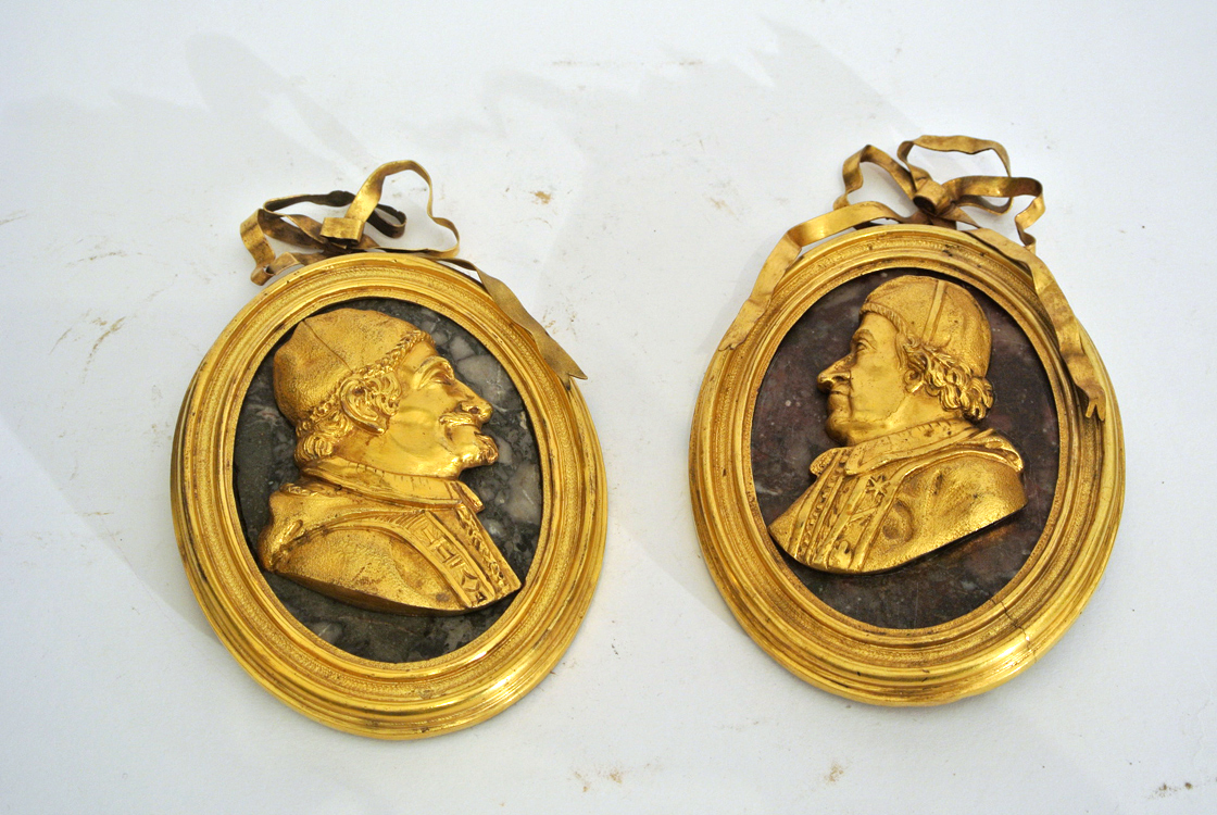 Roman School 18th century. A fine pair of gilt bronze profile portraits of two popes. Roman School