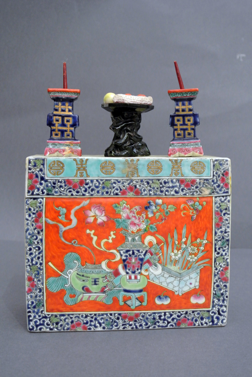 Chinese School 19th century. A polychrome porcelain ritual candelabra, with two flames and a