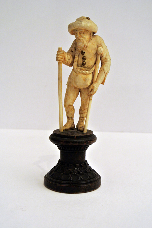 German School 19th century. A fine carved ivory sculpture depicting `an old farmer with shoulder