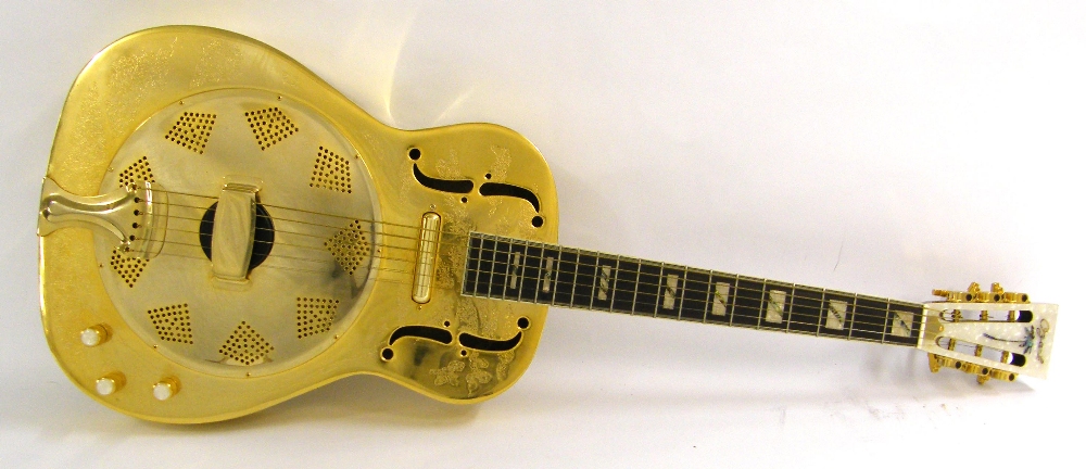 Ozark electric resonator guitar, with brass machine engraved body, electrics appear to be in working