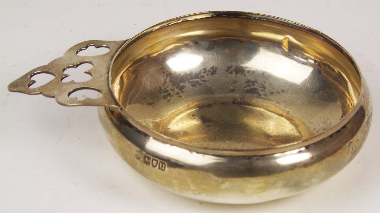 A bulbous circular porringer, with pierced handle, maker`s mark of Goldsmiths & Silversmiths Co.