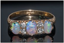 18ct Gold Diamond And Opal Ring Set With 3 Polished Opals Between 4 Round Cut Diamonds In A Gallery