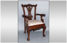 A Georgian Style Apprentice Open arm Mahogany Carvers Chair with elaborate pierced back splat.