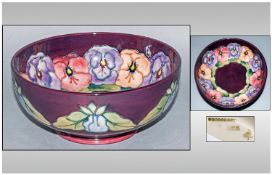 W Moorcroft Footed Bowl `Pansy` pattern 3.5 inches high, 8 inches diameter.