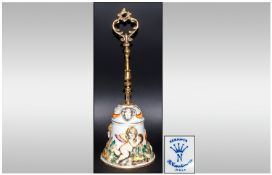 Capo Di Monte Bell, with gilt decorative handle. The bell depicting cherubs in a garden setting