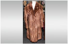 Ladies Musquash Full Length Coat, fully lined. Slit pockets and hook and eye fastening.