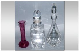 Three Pieces of Glass Ware comprising two decanters and ruby red bud vase. Various sizes.