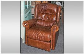 A Brown Leather Reclining Adjustable Arm Chair