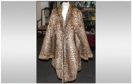 Ladies Three Quarter Length Ocelot Coat, fully lined. horizontal pelts to cuffs. Approximate size